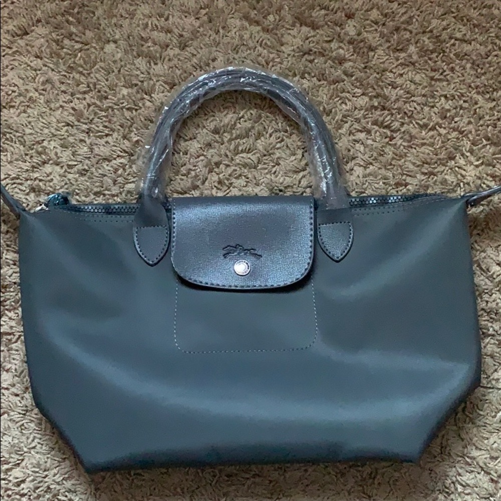 A gray Longchamp tote bag
